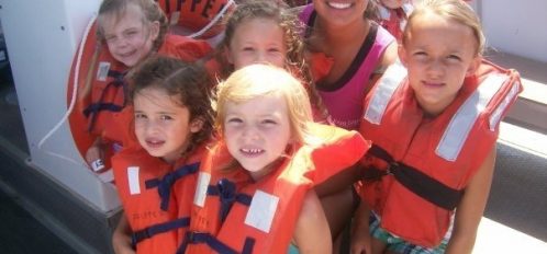 children wearing life jackets